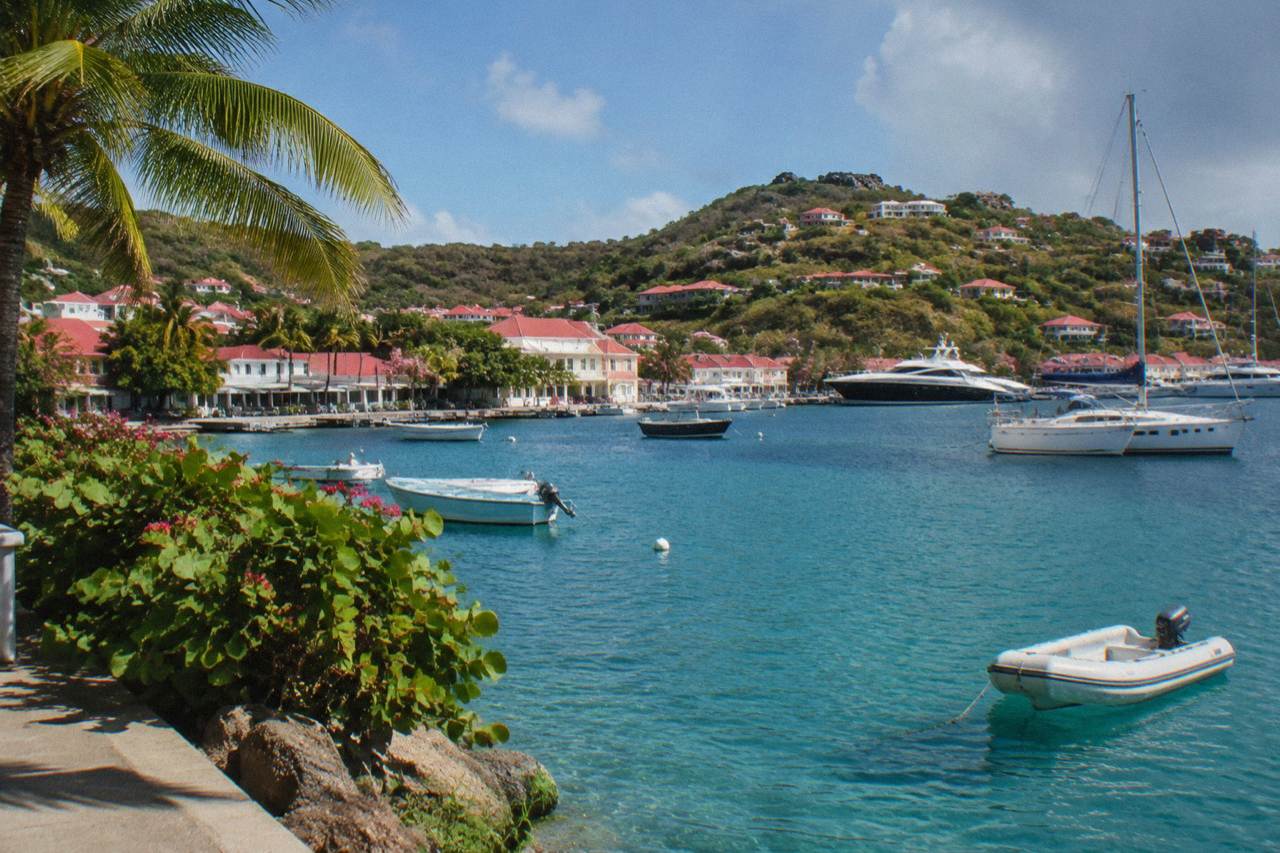 Red-roofed houses on a green hillside above the harbour of Gustavia on St Barts