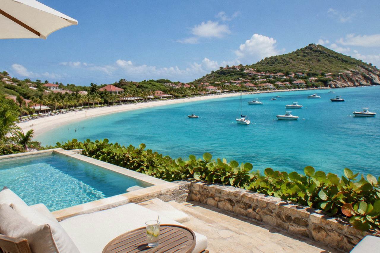A luxury hotel terrace above a turquoise bay on a small Caribbean island