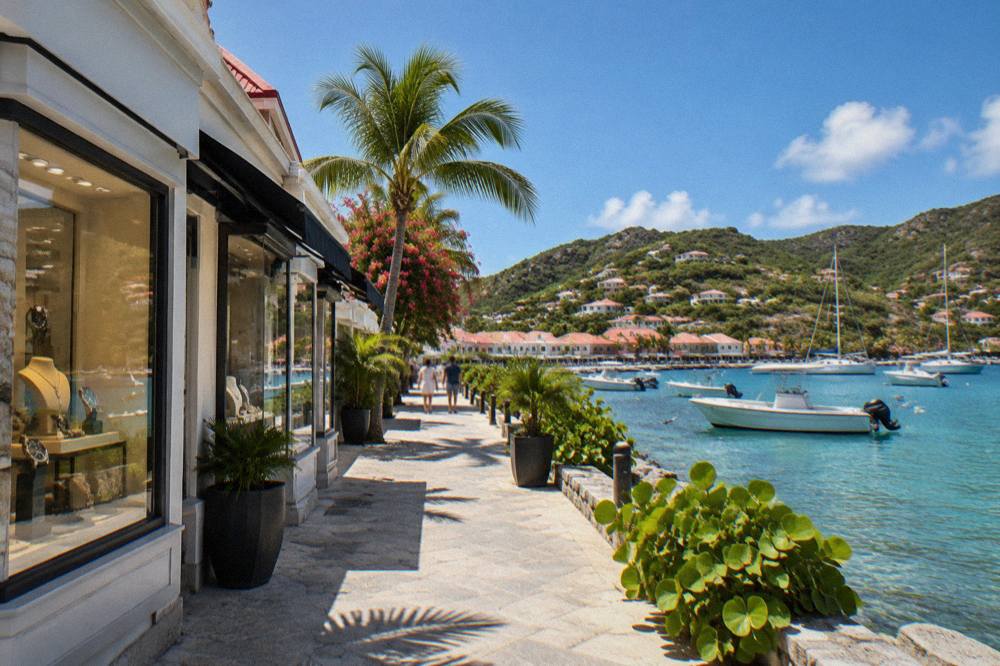 Display windows of high-end jewelry and watch boutiques on a sunny Caribbean street