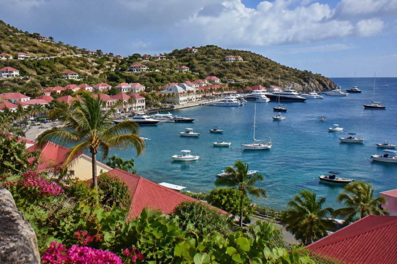 Harbour town of Gustavia on St Barts with boats anchored in the bay and red roofs on the hillside