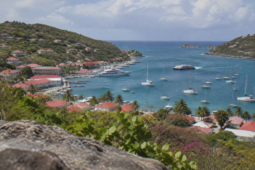 Sailing boats and a ferry in the anchorage at Gustavia, St Barts, seen from the hills above the town