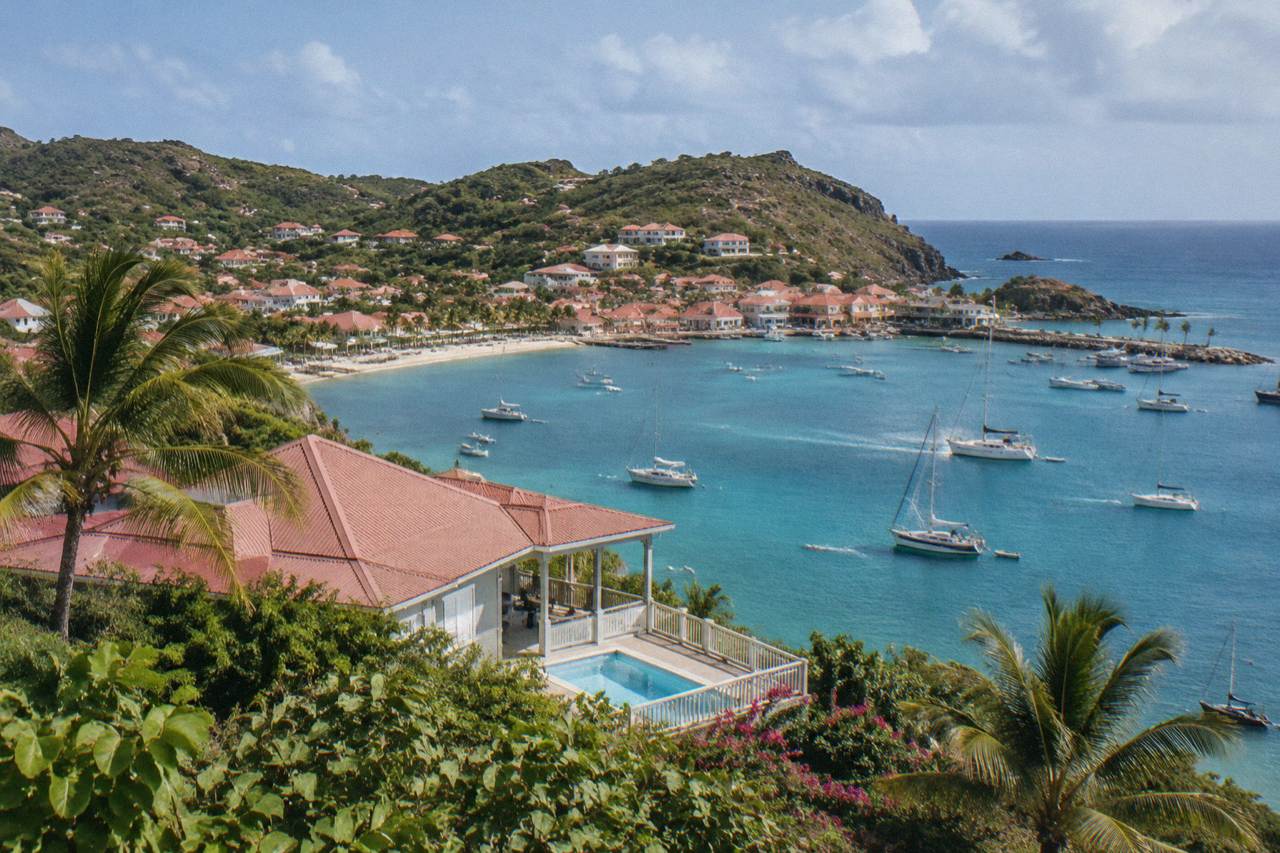 A hillside villa overlooking a Caribbean bay with turquoise water