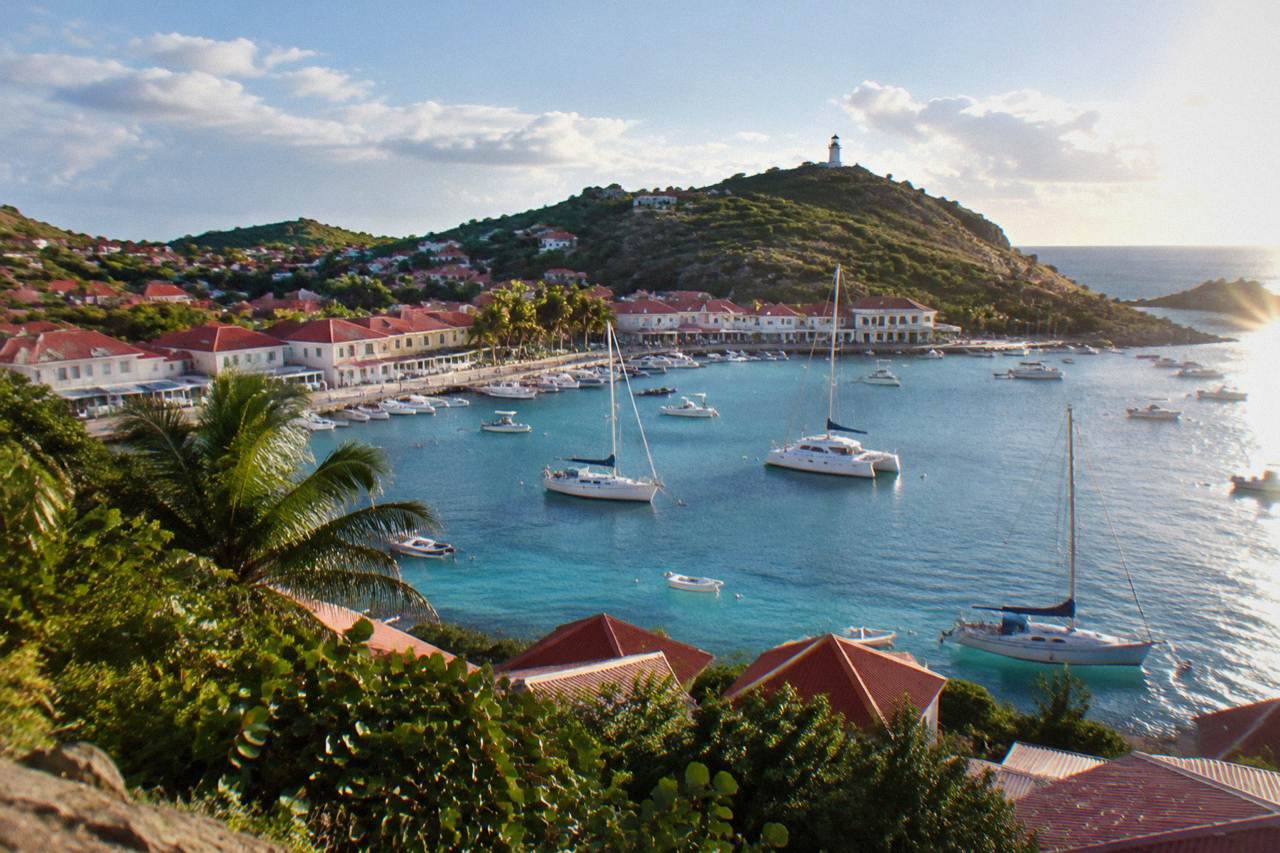 Red rooftops and sailboats in Gustavia harbour seen from the hills of St Barts