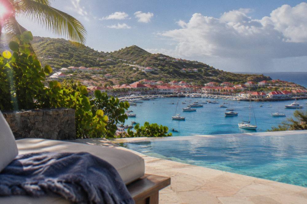 A hillside villa with a pool overlooking the turquoise sea on the coast of St Barts