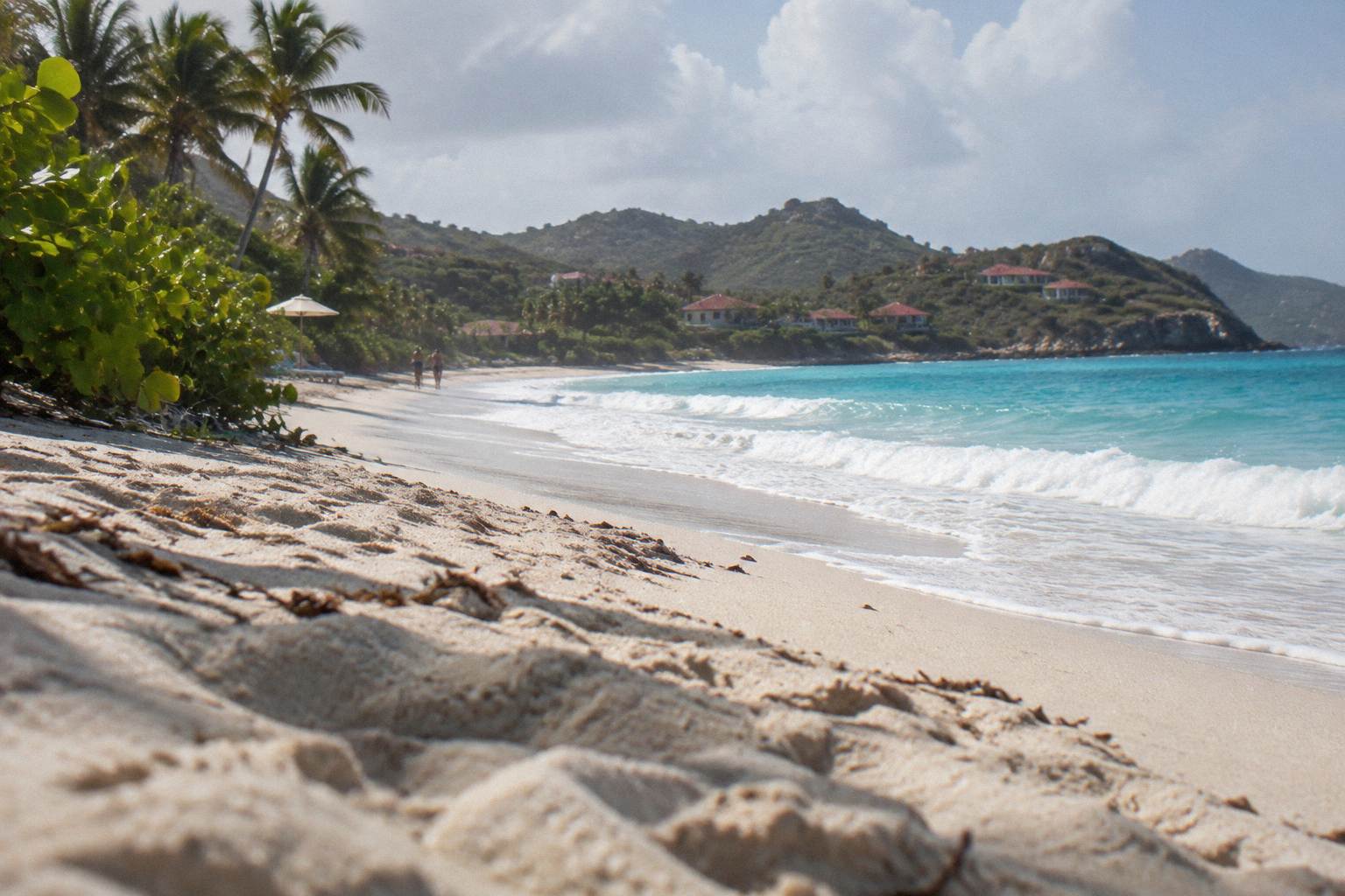 Broad quiet bay with palms and a single resort on the shore