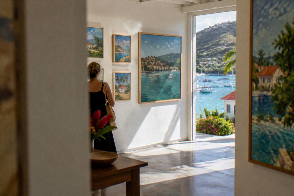 An art gallery interior with framed paintings on white walls in Gustavia