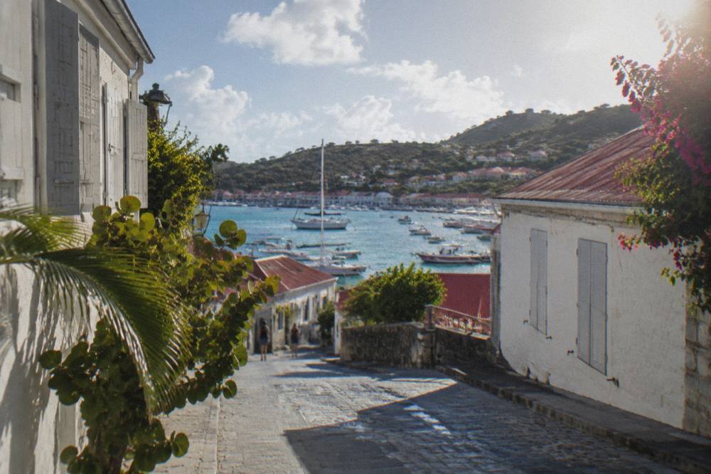 Narrow street in Gustavia with whitewashed stone buildings and closed shutters