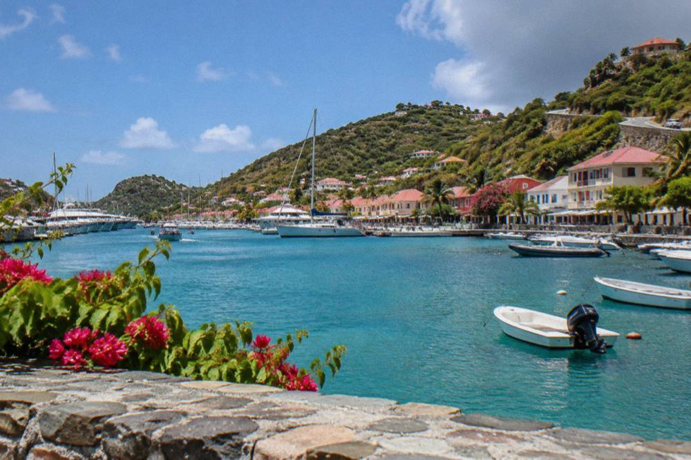 A hillside road winding above the coast with sea views in St Barts