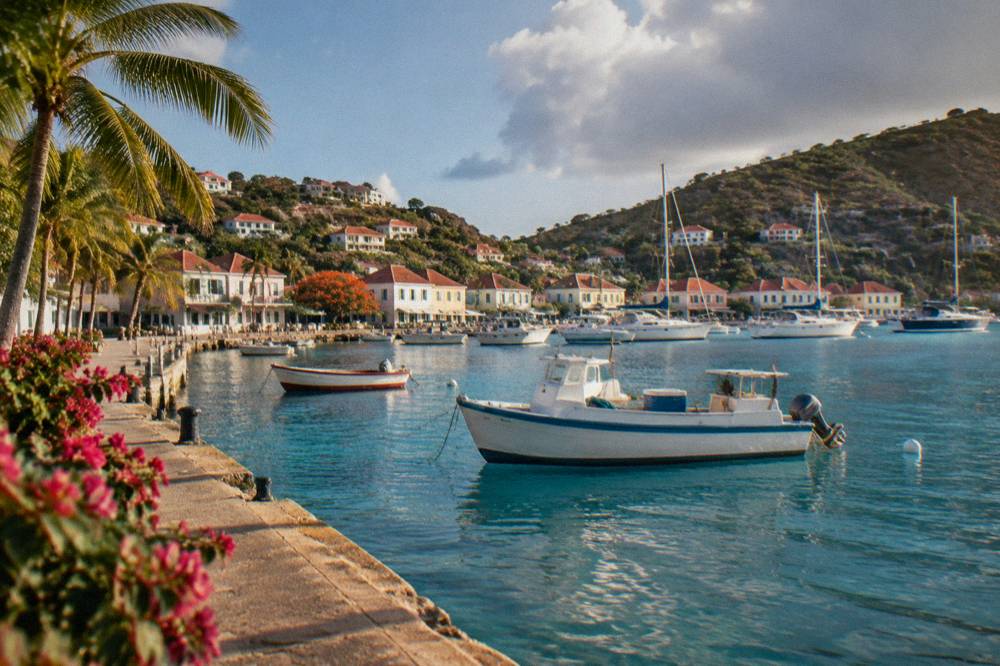 A quiet village waterfront with small fishing boats on St Barts