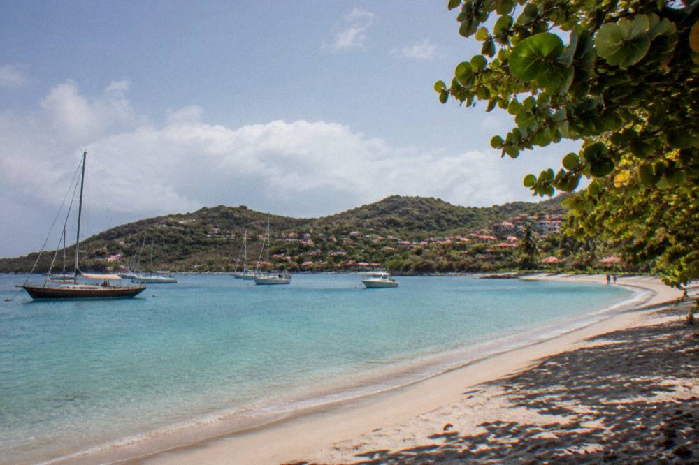 Wooden sailing boats moored in a harbour with hills behind, St Barts