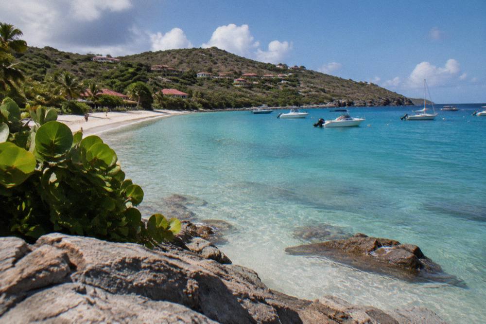 A view along a Caribbean coastline with green headlands and clear water