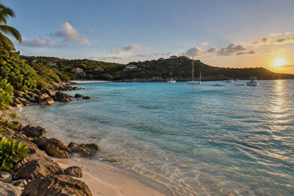 Shallow clear water over pale sand in a small Caribbean cove