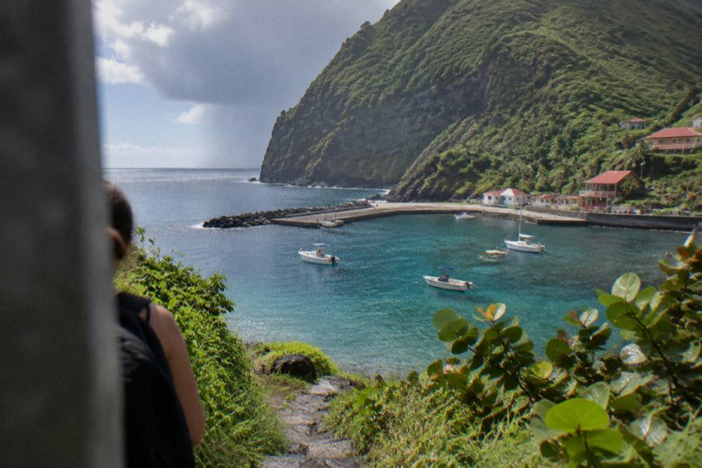 A rainforest trail climbing through cloud and green vegetation on a steep island