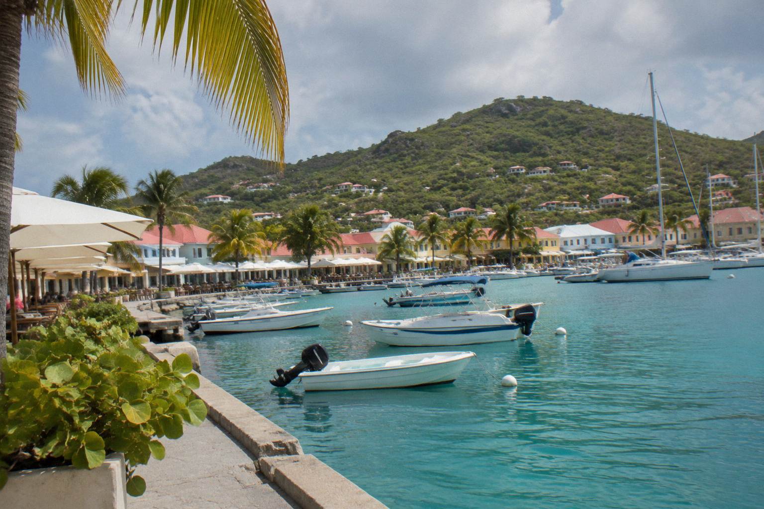 Harbour with a ferry alongside a quay and low hills behind