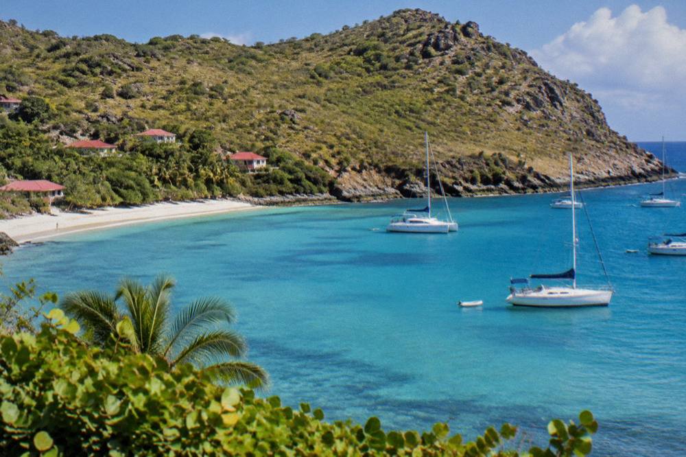 Anchored boats and turquoise shallows at Colombier bay on St Barts