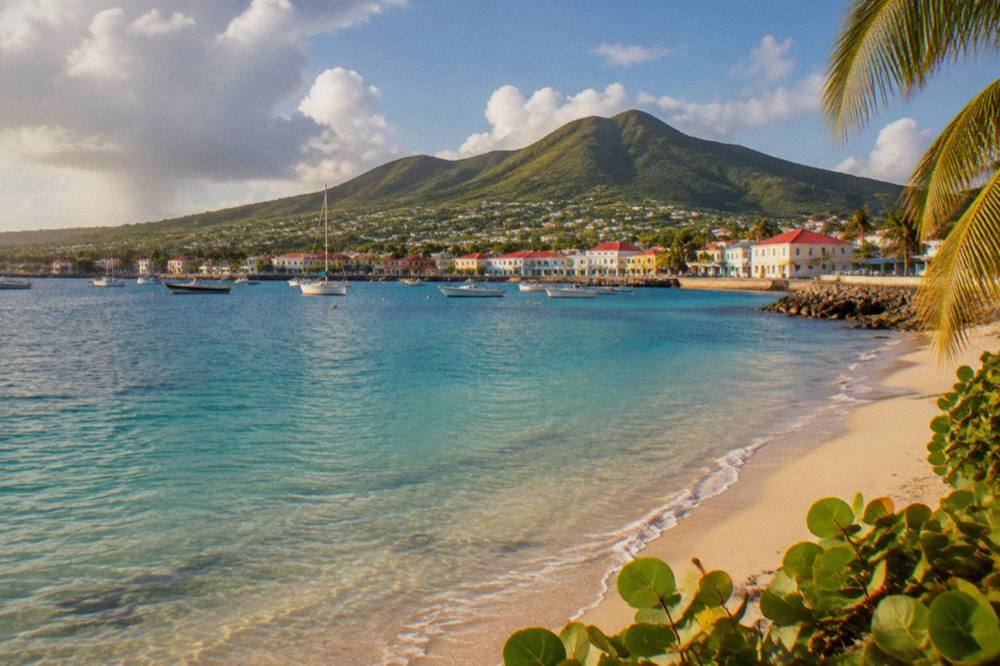 A quiet Caribbean beach with pale sand, clear shallow water and no people