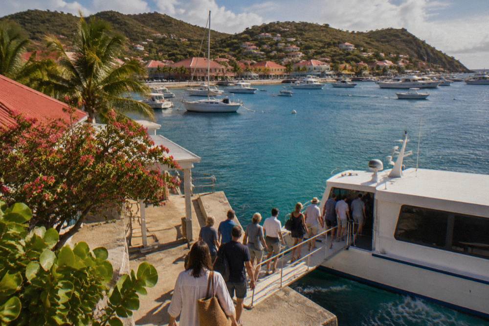 Passengers boarding a passenger ferry at a small Caribbean terminal