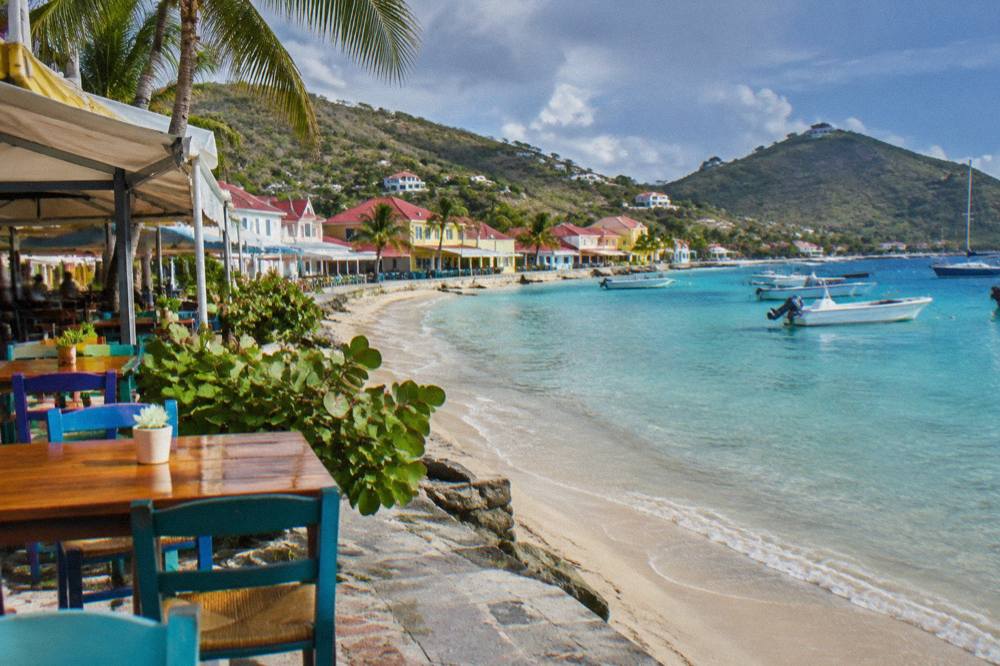 Colorful waterfront buildings along a Caribbean harbour promenade