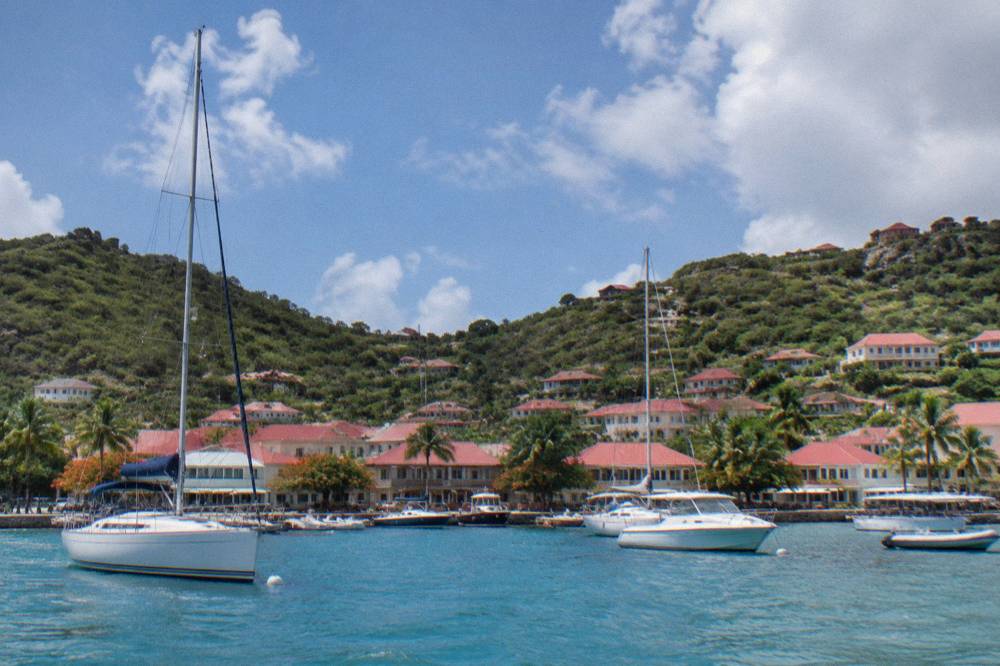 The harbour town of Gustavia on St Barts with red roofs and boats at anchor