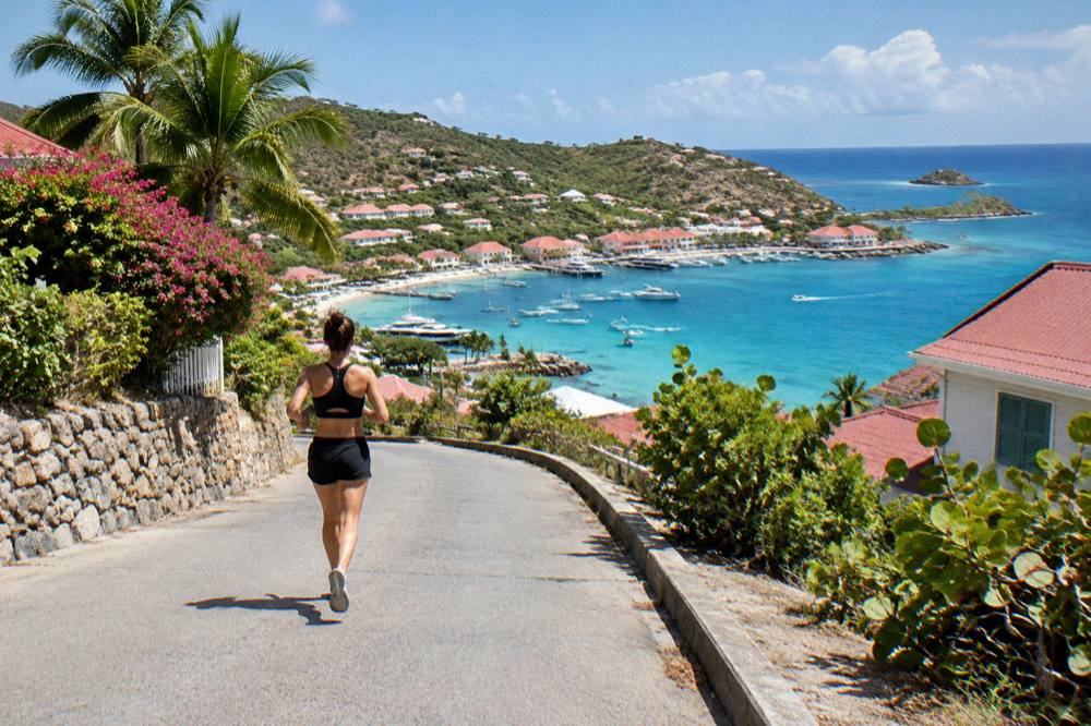 A hillside road on St Barts winding down toward a north shore bay with turquoise water