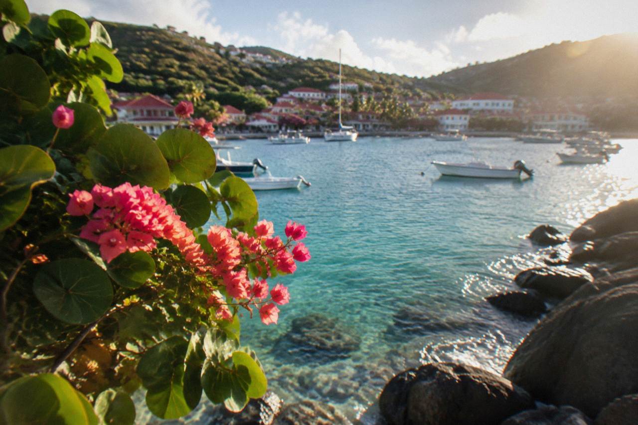 Turquoise water over a rocky shoreline in St Barts with snorkel-ready reef visible near the surface