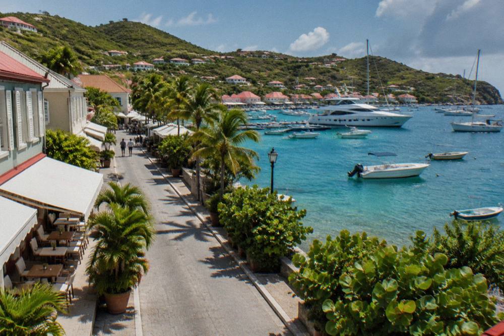Yachts moored in a small Caribbean harbor at golden hour