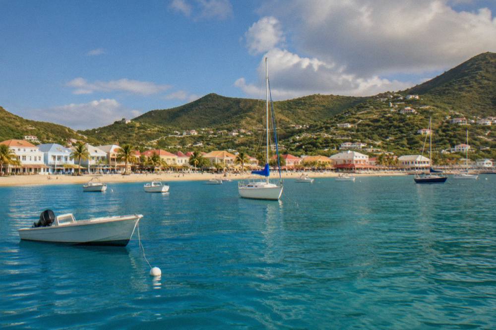 The waterfront of Philipsburg, Sint Maarten, seen from the sea with boats at rest on calm water