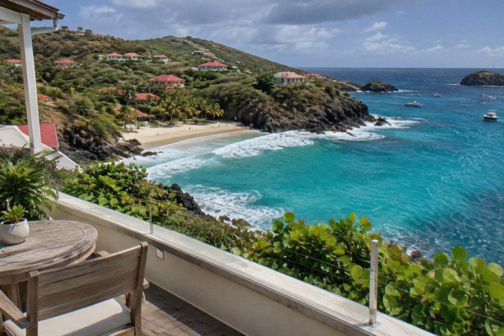 A hotel room terrace with an open sea view and morning light