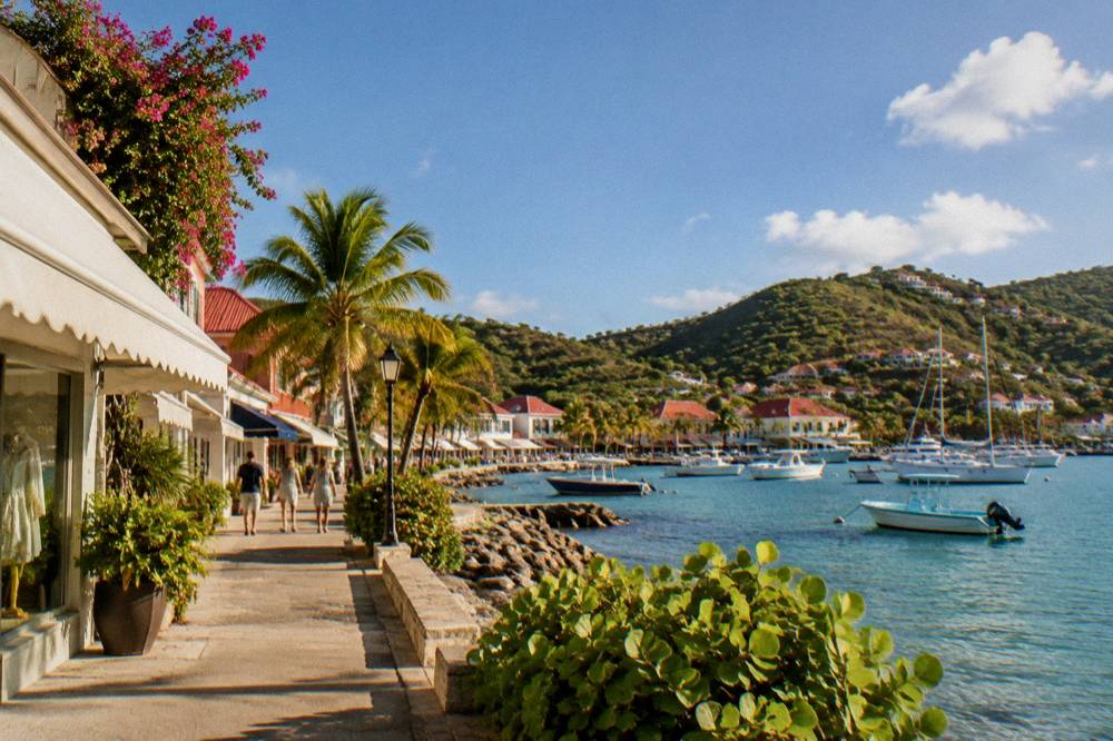 Boutique storefront with European-style awnings on a sunny Caribbean street