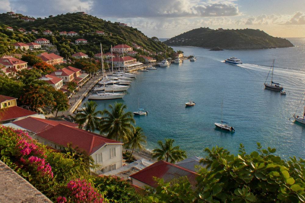 Passenger ferry crossing open blue water toward a green island coastline