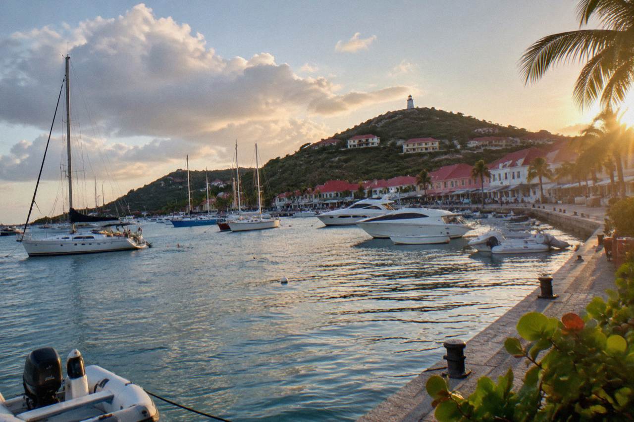 Evening view across Gustavia harbor in St Barts with yachts moored near the waterfront buildings