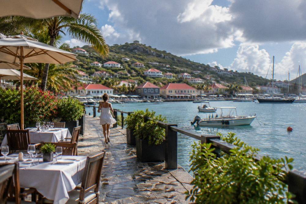 Tables set for dinner on a terrace near the harbor in Gustavia, St Barts