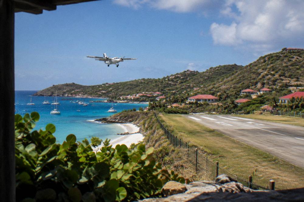Small turboprop aircraft on the short runway at Gustaf III Airport in St Barts