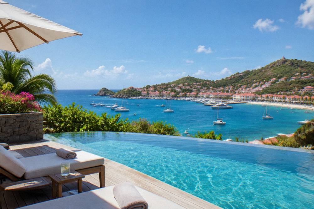 A quiet infinity pool deck overlooking the sea at a Caribbean luxury hotel
