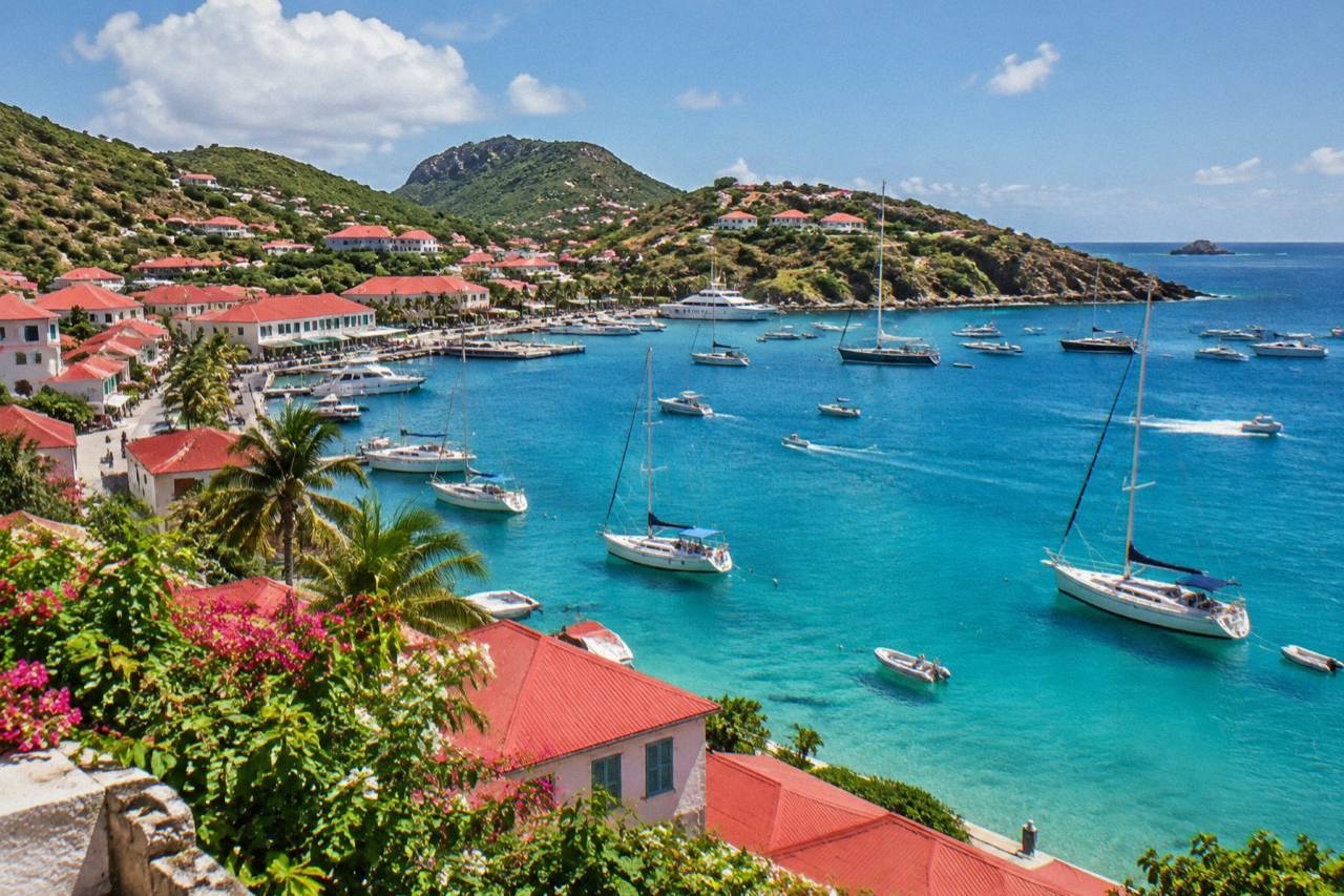 Harbor town of Gustavia on St Barts with boats moored in clear turquoise water