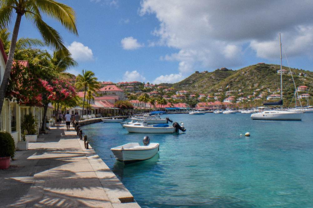 Level harbourfront street in Gustavia with shops and anchored boats