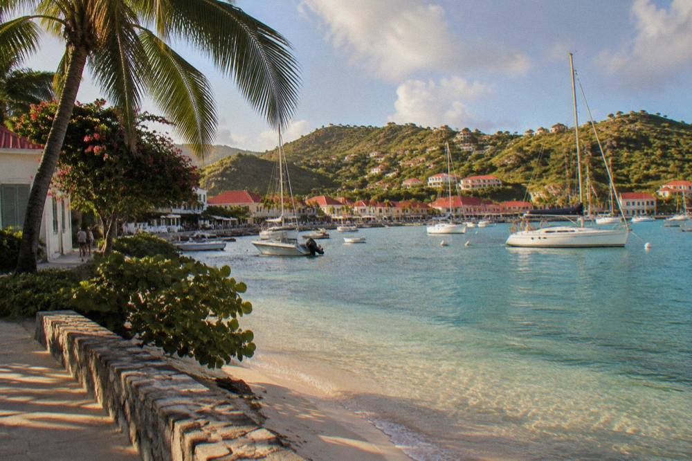 A calm bay on St Barts with shallow water over sand and hills behind