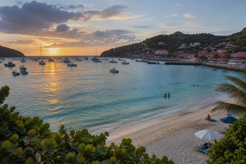 A wide public beach on St Barts with shallow water and a few umbrellas