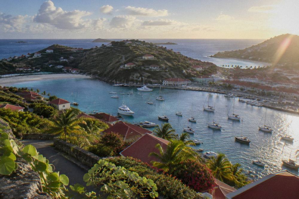 Two beaches on either side of a green headland on St Barts seen from above