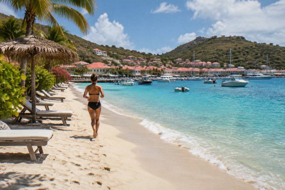 Sun loungers and a palm-thatched shade on a white sand beach in St Barts