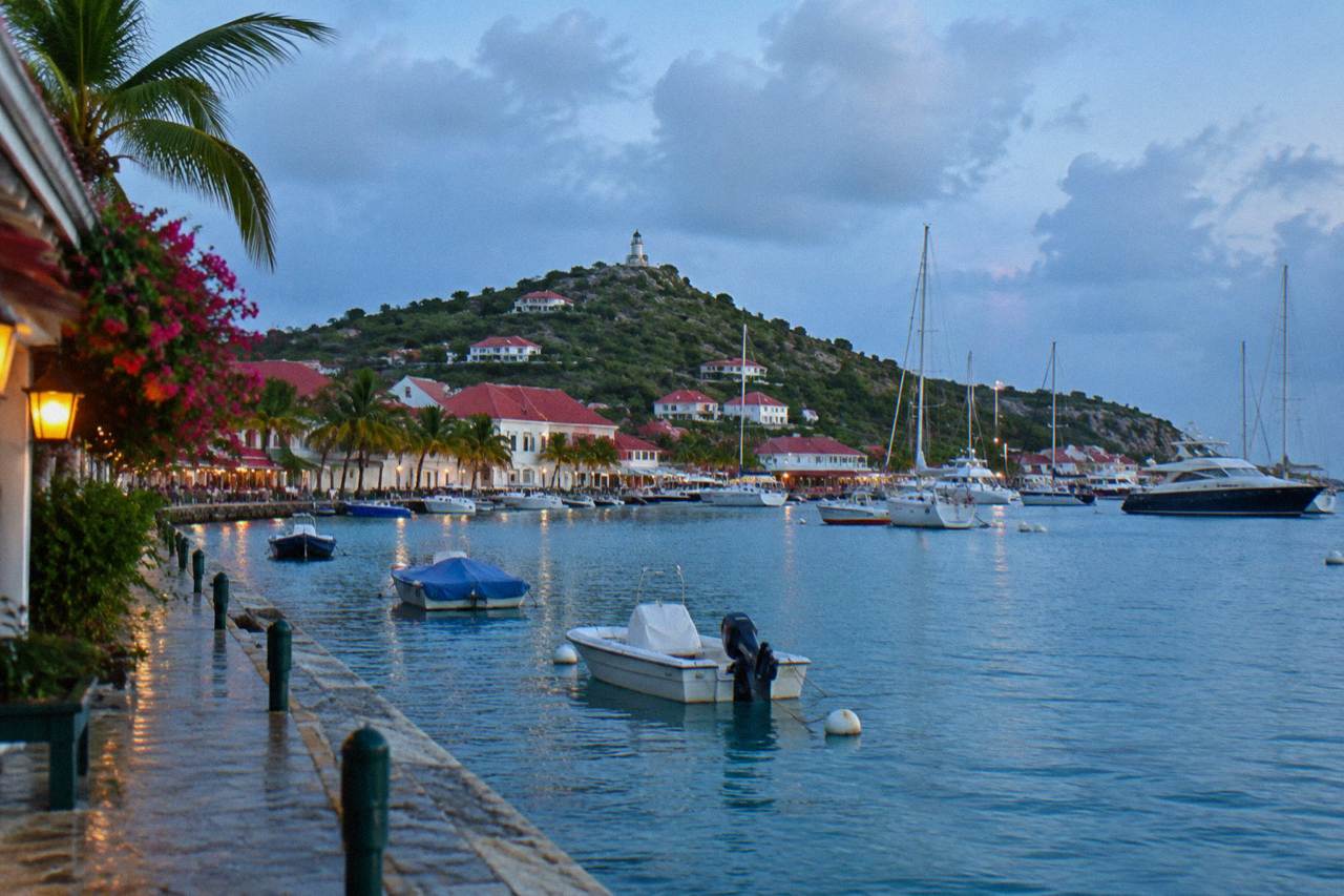 Colorful carnival costumes and decorations along a Caribbean harbourfront