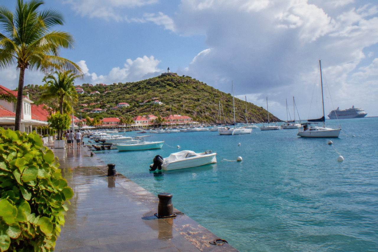 Cruise ship anchored offshore beyond the sailboats of Gustavia harbor