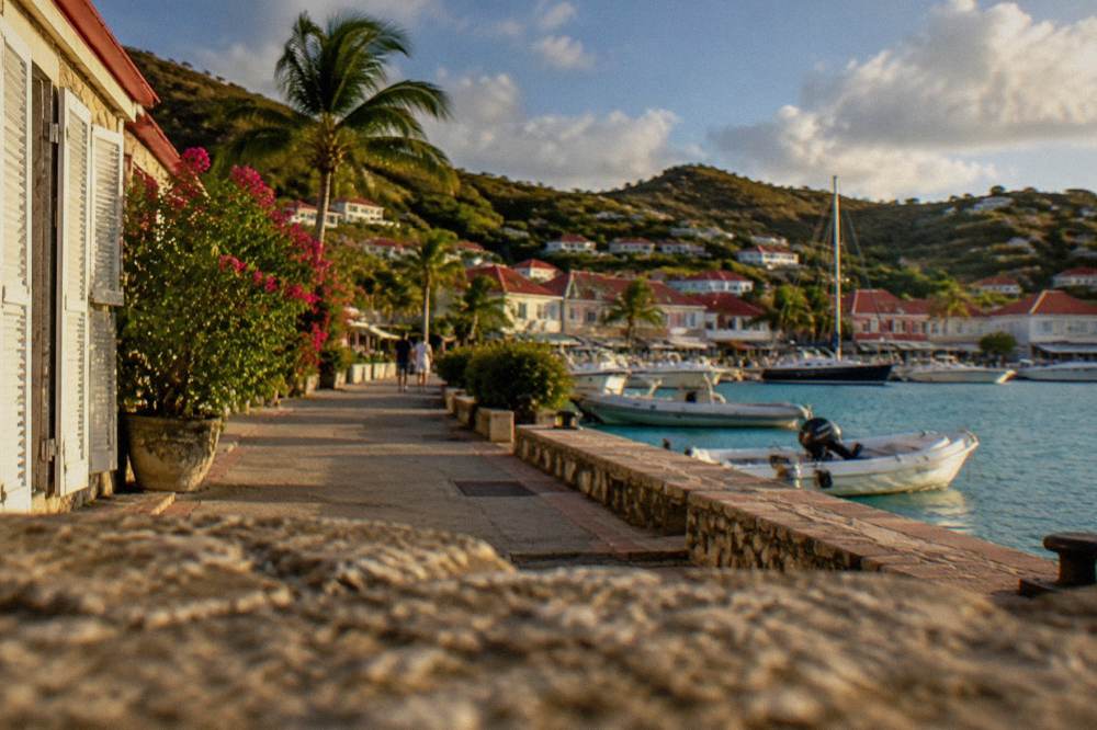 Pedestrian street in Gustavia with boutiques and stone buildings in Caribbean sunlight