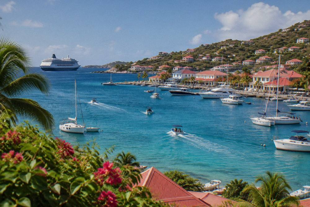 Small cruise ship at anchor in the bay off Gustavia with tenders crossing the water toward town