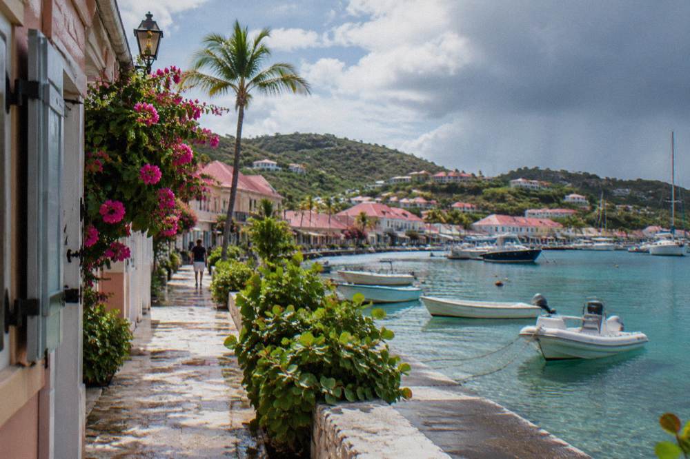 Pastel shops and stone buildings along a narrow street in Gustavia on St Barts