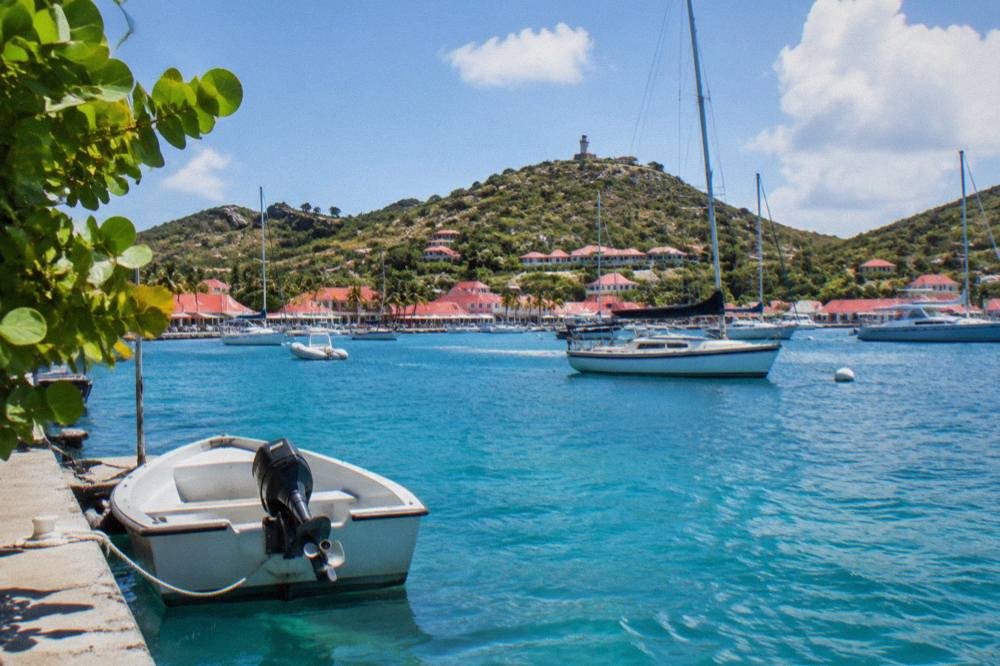 Sailboats anchored in Gustavia harbor on a bright morning