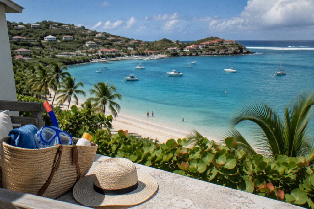 Beach bag with snorkel masks, sunscreen and a sun hat on a terrace overlooking the sea