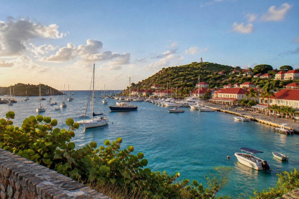 A turquoise channel of shallow water between two Caribbean islands seen from a hillside