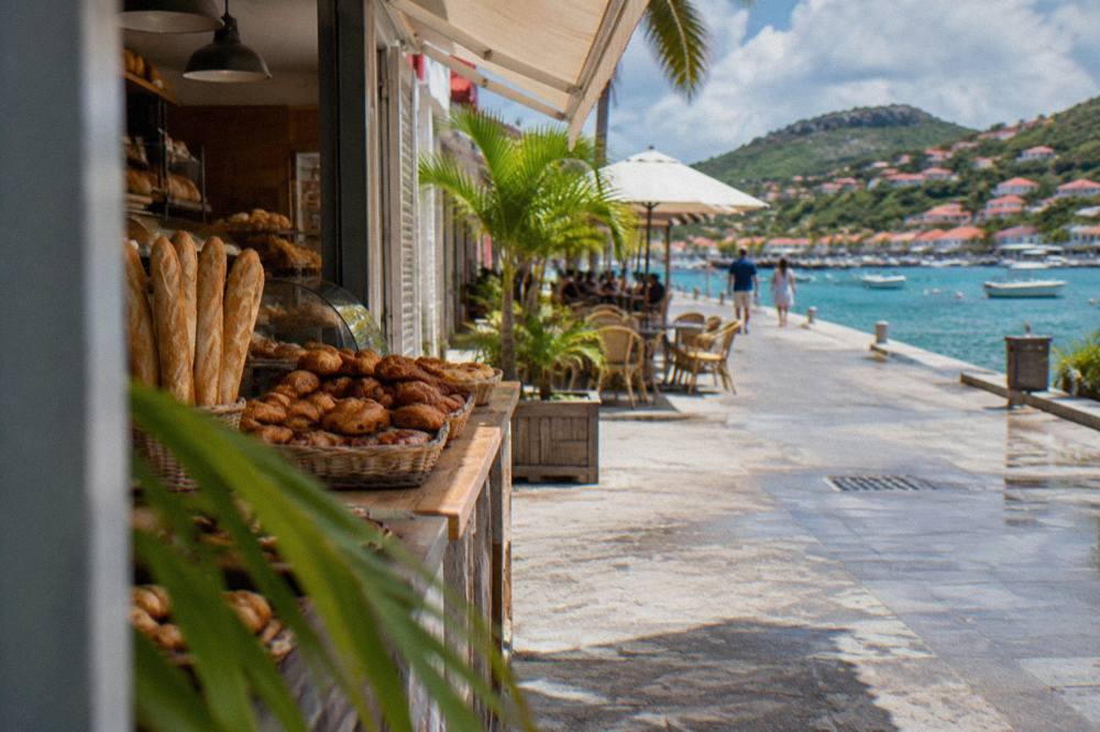 Fresh baguettes and pastries arranged on the counter of a small bakery