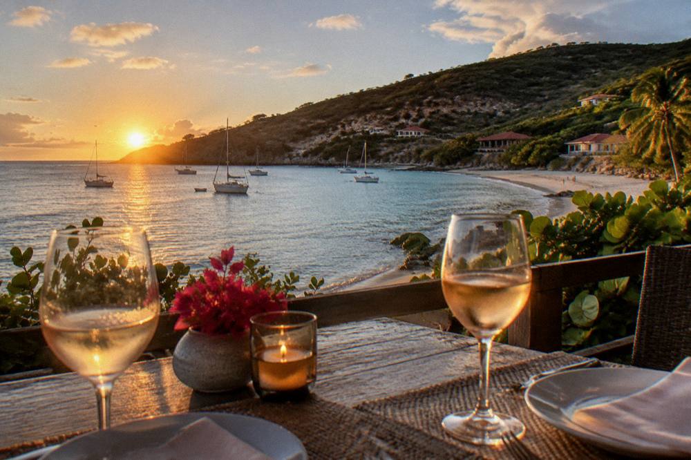 A table set for two overlooking a harbour at dusk